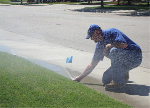 a Mississauga irrigation repair pro is checking the sprinkler head